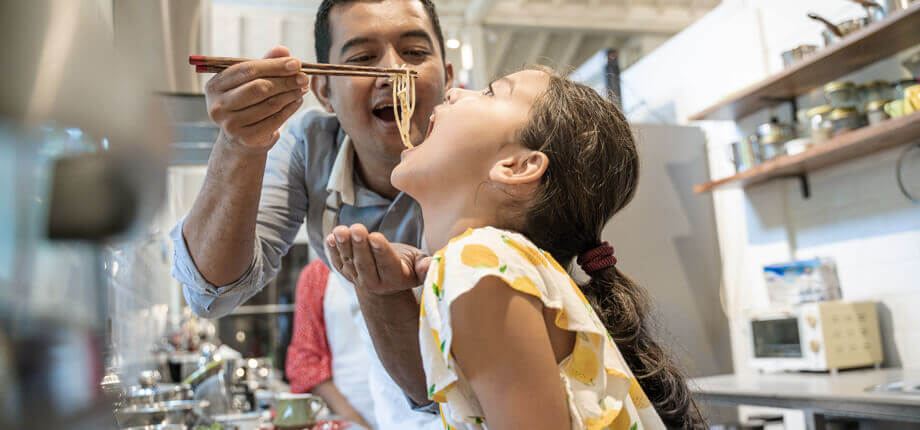 Father and daughter having fun in the kitchen