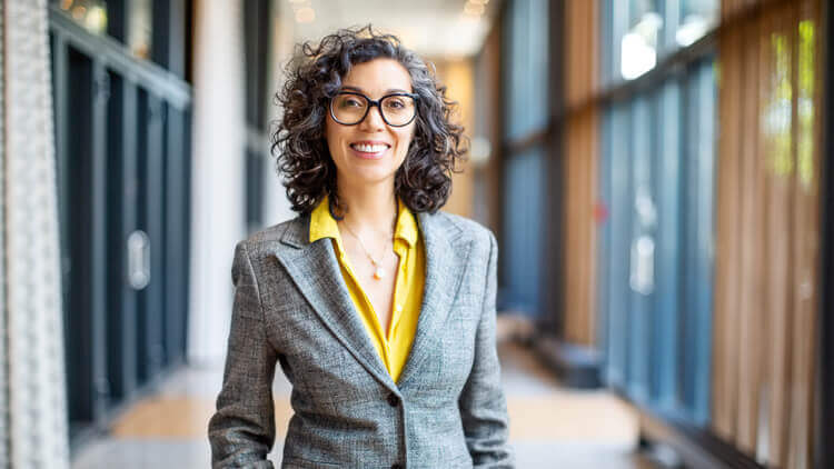 Business woman smiling stood in an office 